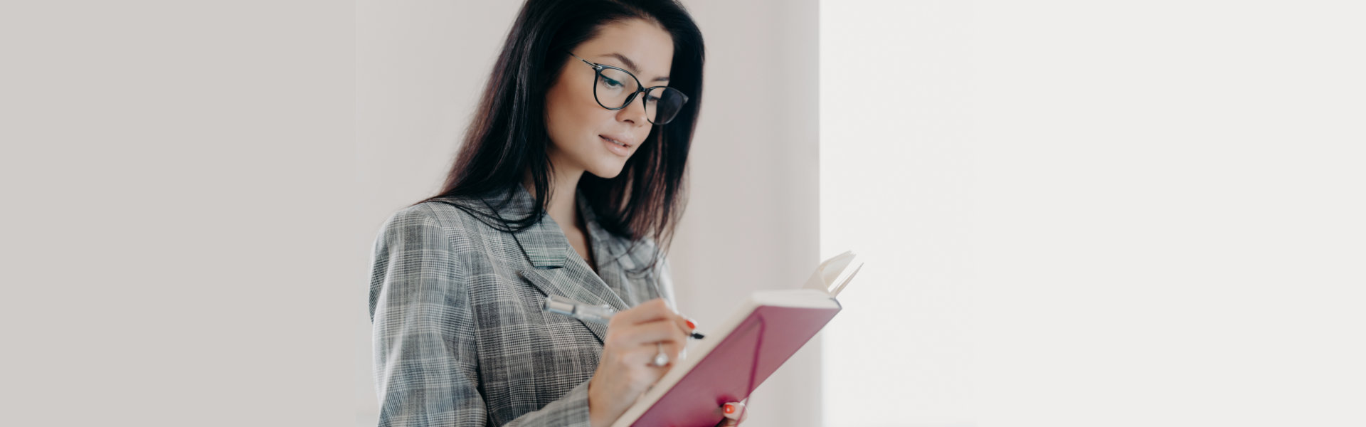 A woman writing something on a notebook