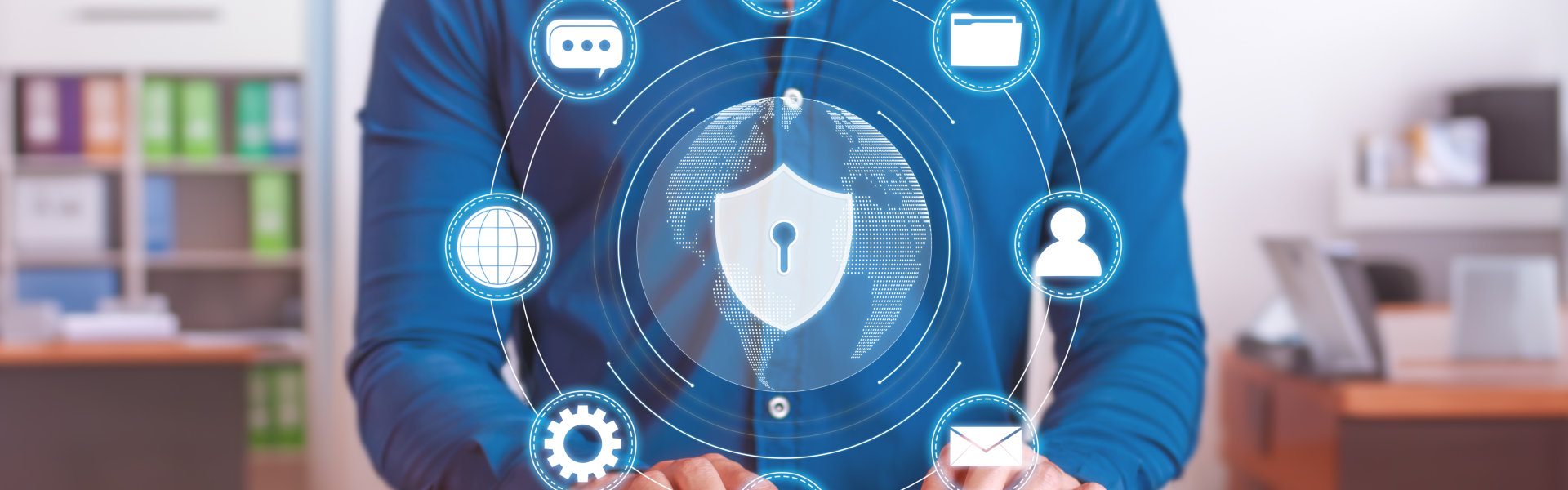A person in a blue shirt interacts with digital security icons and a globe, emphasizing cybersecurity and data protection.